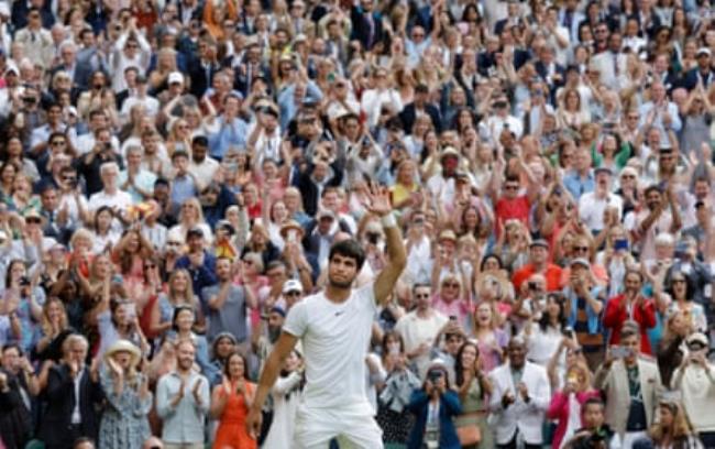 Carlos Alcaraz acknowledges the crowd on Centre Court after his victory