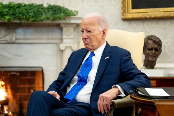 President Joe Biden sits in the Oval Office of the White House, Friday, Feb. 9, 2024.