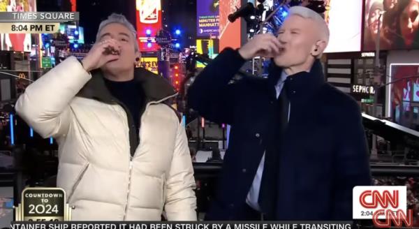 Andy Cohen and Anderson Cooper down their shot glasses of tequila together for the New Year. 