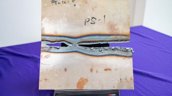 A me<em></em>tal plate showing damaged caused by 'DragonFire', a British military laser weapon system