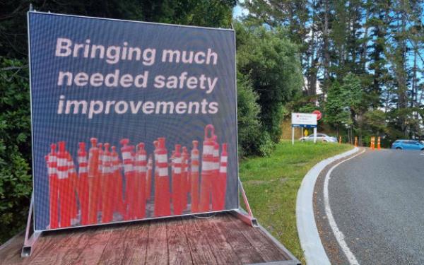 Mystery surrounds to<em></em>ngue in cheek digital billboard placed by an intersection wher<em></em>e Waka Kotahi has recently finished work. Junction Road and State Highway 3.