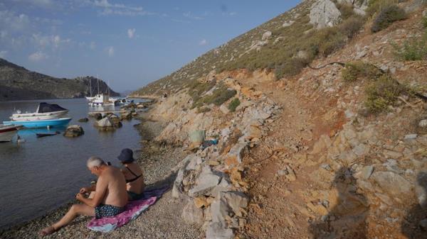 A rocky path near Saint Nikolas Beach in the Pedi district in Symi, Greece