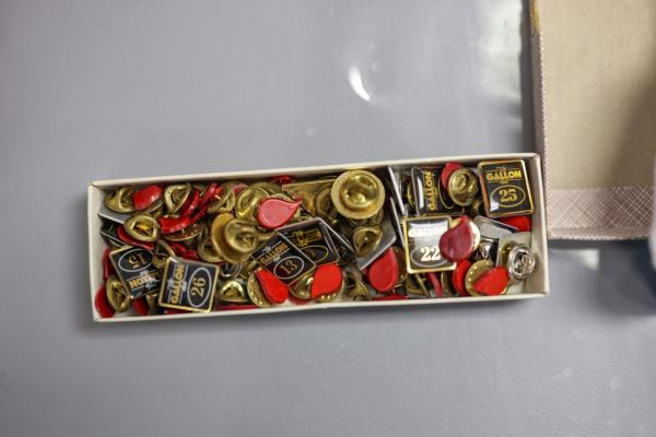 A box of blood do<em></em>nation trinkets including pins that say the amounts of gallons do<em></em>nated to blood drops.