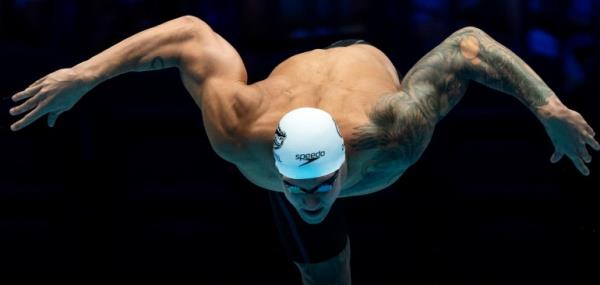Swimmer leaps off starting block.