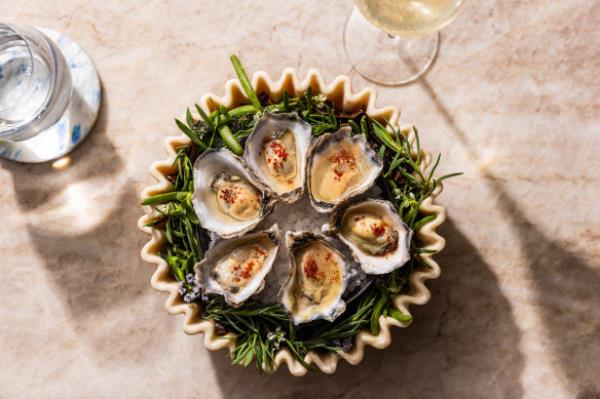Oysters charred with smoked wagyu fat and coco<em></em>nut vinegar.