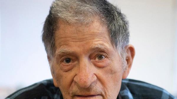 Son Franzese wearing a blue plaid shirt.