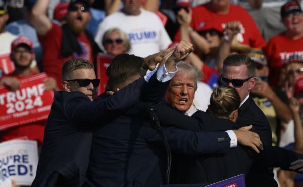 Republican presidential candidate, former U.S. President Do<em></em>nald Trump is whisked away by Secret Service after shots rang out at a campaign rally at Butler Farm Show Inc. on July 13, 2024 in Butler, Pennsylvania.