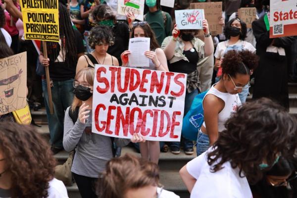 New York City high school students hold sign that says 