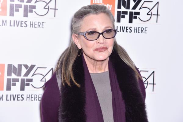 Carrie Fisher attending the premiere of 'Bright Lights: Starring Carrie Fisher and Debbie Reynolds' at the 54th New York Film Festival in a purple sweater