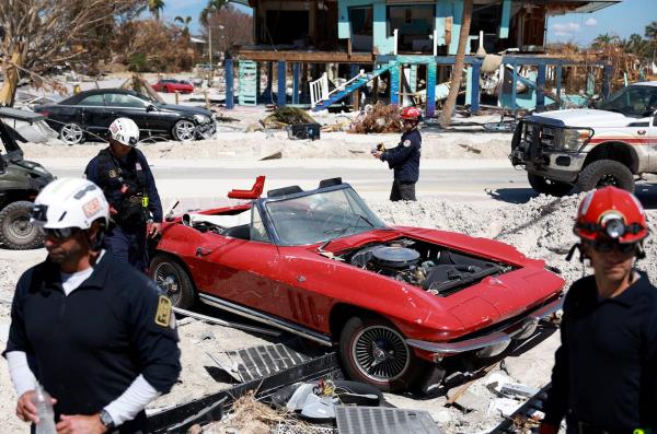 FORT MYERS BEACH, FLORIDA - OCTOBER 03: Members of the City of Miami Florida Task Force 2 Search and Rescue team check homes for victims in the wake of Hurricane Ian on October 3, 2022 in Fort Myers Beach, Florida. The death toll in the state from Ian rose to at least 100 today following the storm making landfall as Category 4 hurricane, causing extensive damage along the coast as rescue crews co<em></em>ntinued the search for survivors.  (Photo by Joe Raedle/Getty Images)