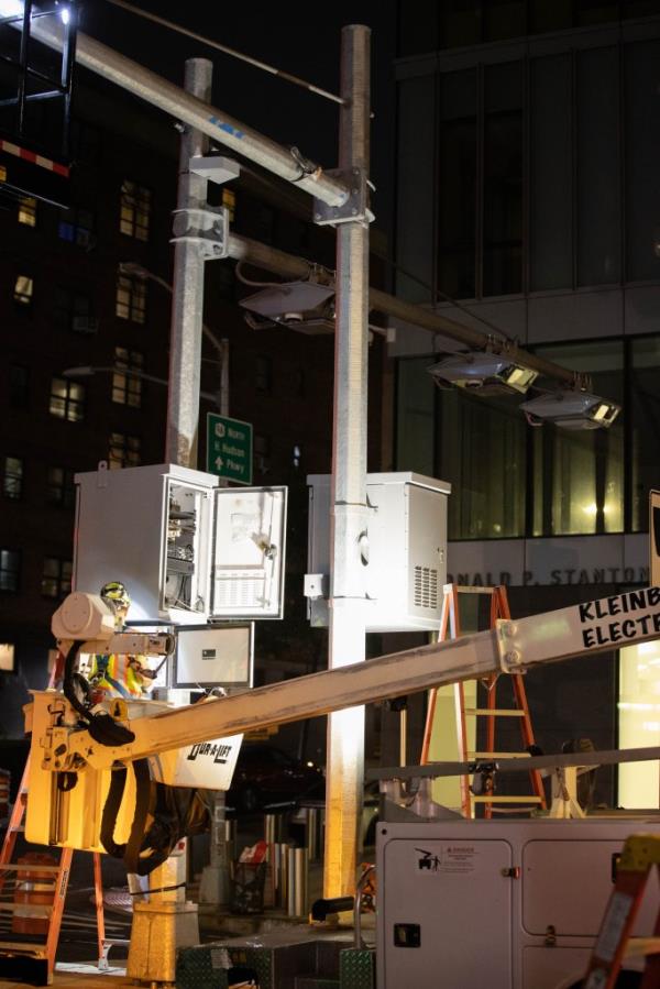 Workers last July installing E-Z Pass and license plate readers. 
