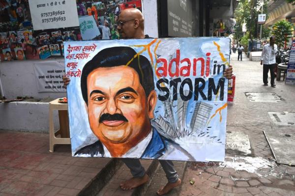 Man holds painting of  Gautam Adani 