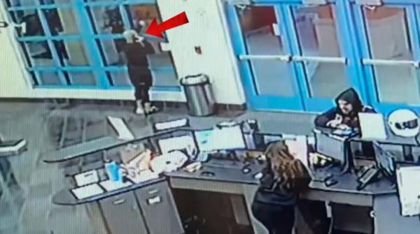 Footage of two men entering the gym.