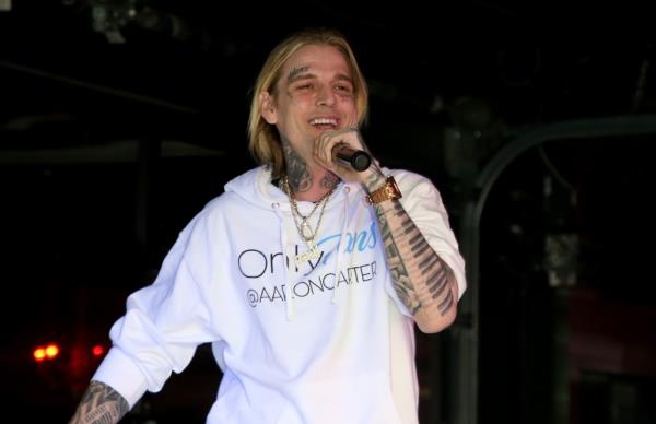 Aaron Carter performing on stage.