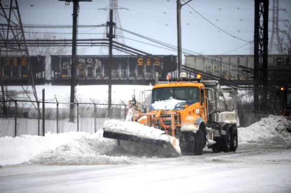 A plow removes ice and snow  along the Lake Erie shoreline on December 24, 2022 in Hamburg, New York