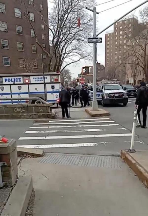 NYPD enter the apartment building after the shooting.