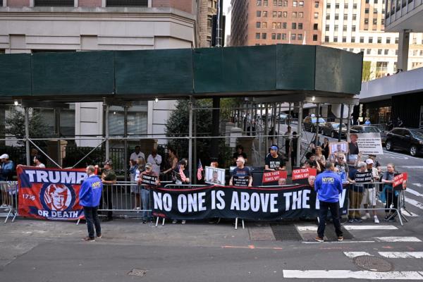 Protestors for and against Trump wait outside James' Manhattan office ahead of his second deposition. 