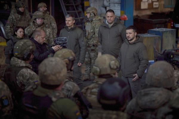 Ukrainian President Volodymyr Zelenskyy, right, speaks to soldiers at the site of the heaviest battles with the Russian invaders, in Bakhmut, Ukraine.