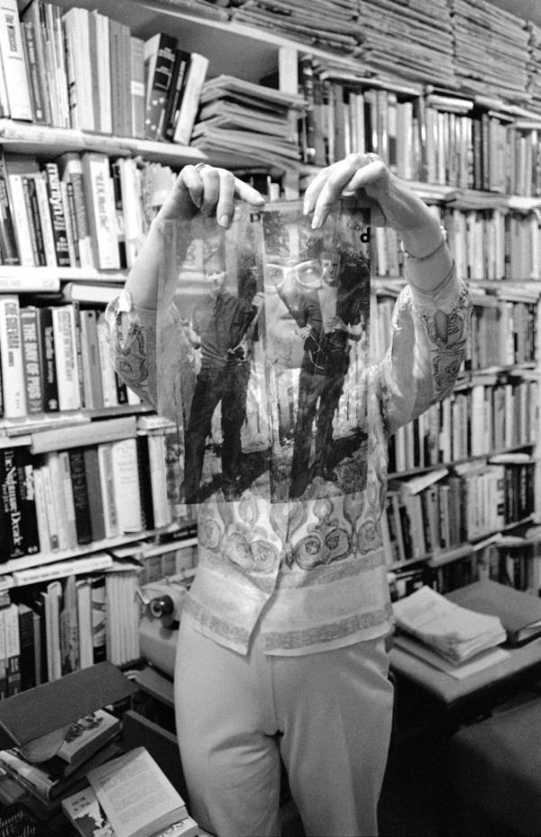 Ferrell holds up a photo transparency purporting to show Lee Harvey Oswald with both a pistol and a rifle.