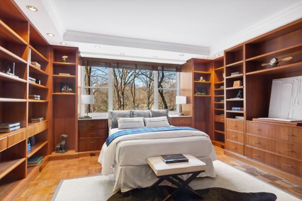 Another bedroom, surrounded by bookshelves, inside the Fifth Avenue lair.