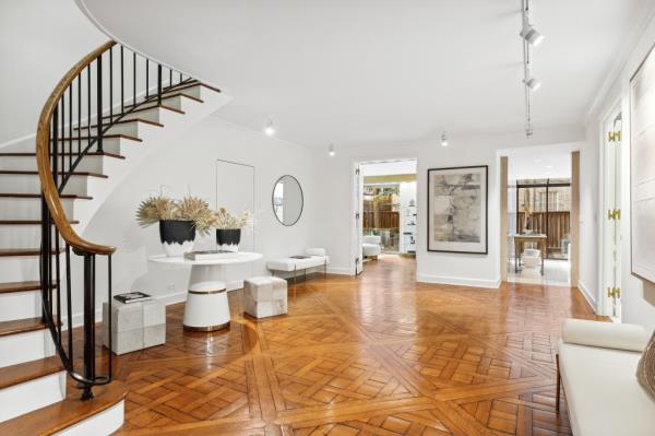 The spread boasts Parquet de Versailles floors and a dramatic curved staircase.