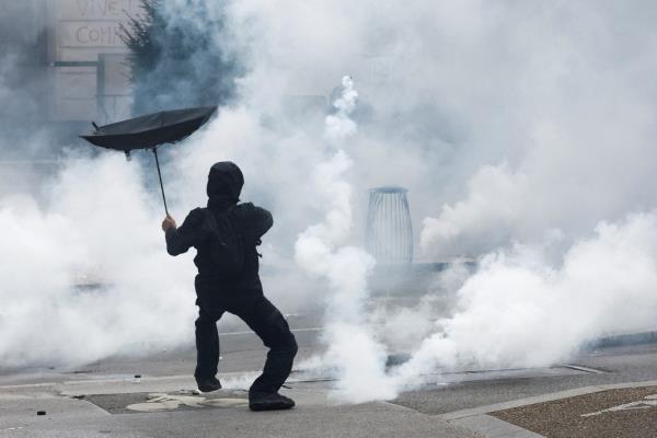 A demo<em></em>nstrator holds an umbrella.