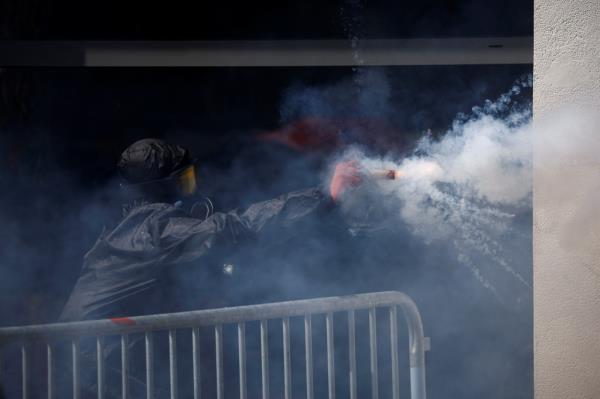 A demo<em></em>nstrator fires fireworks towards the police during the traditio<em></em>nal May Day labour march.