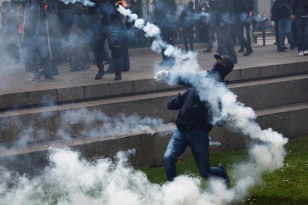 A demo<em></em>nstrator throws tear gas during the May Day protest in Nantes.
