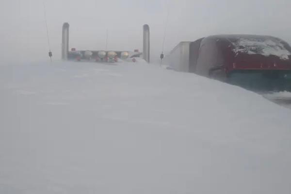 A truck in South Dakota stuck on the highway due to snow covering it.