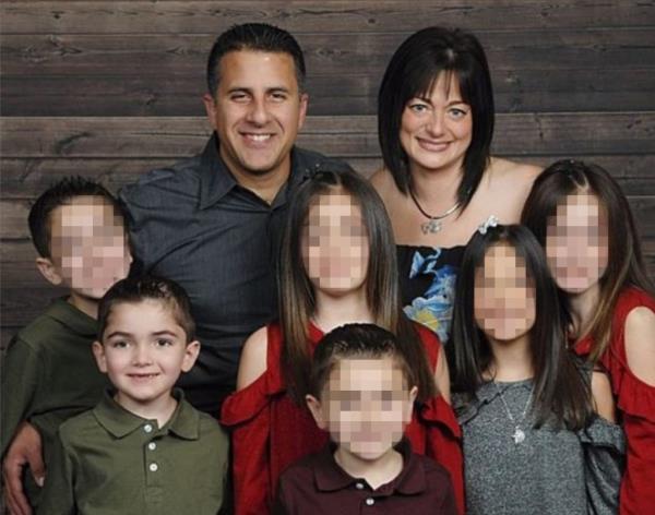 Michael Valva, Angela Pollina and their families in a portrait.