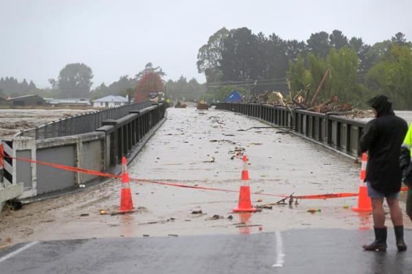 Redcliffe Bridge is closed off as debris piles up along the Tutaekuri River in the suburb of Taradale on February 14, 2023 in Napier, New Zealand.