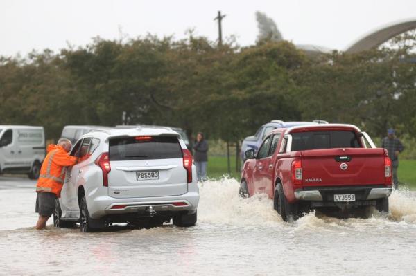 Traffic drives through floodwaters in Kumeu on February 14, 2023 in Auckland, New Zealand.