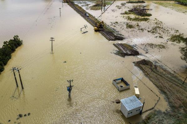 Workers clear the mud and debris from the Redclyffe Substation following Cyclone Gabrielle, in Napier on February 17, 2023.