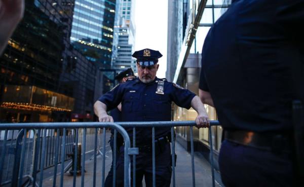 Officers are spotted guarding the Trump Tower ahead of former president Trump's arrival in New York on April 12, 2023. 