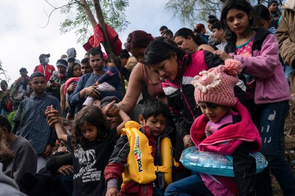 Asylum seekers prepare to cross the Rio Grande on an air mattress into Brownsville, Texas.