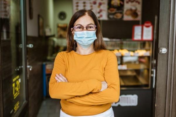 Shot of a senior businesswoman opening her cafe.