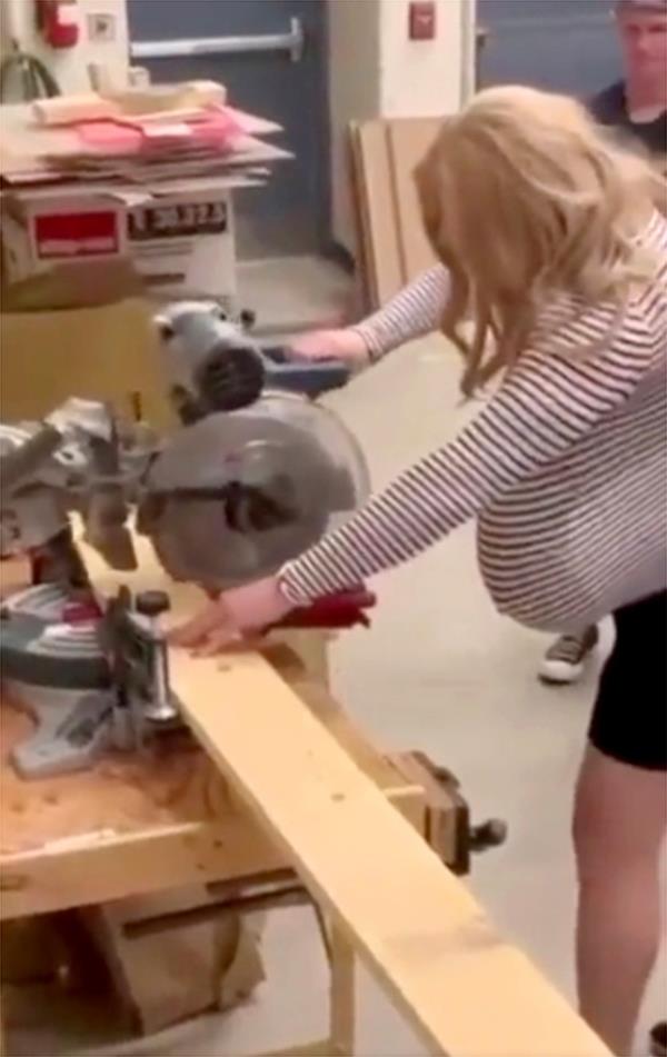 Oakville Trafalgar High School teacher Kayla Lemieux is seen working with a saw in shop class.