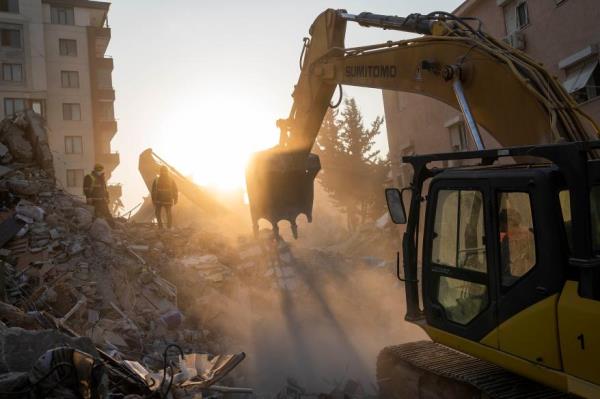 Members of a search and rescue operation work on a building that collapsed during the earthquake in Antakya, southeastern Turkey, Sunday, Feb. 12, 2023.