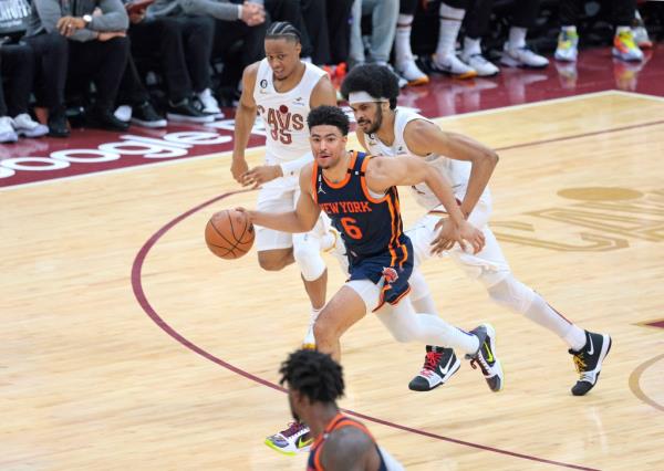 Quentin Grimes drives down court as Isaac Okoro and Jarrett Allen of the Cavaliers give chase during the third quarter. 