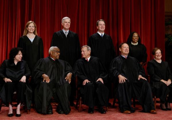 U.S. Supreme Court justices pose for their group portrait at the Supreme Court.