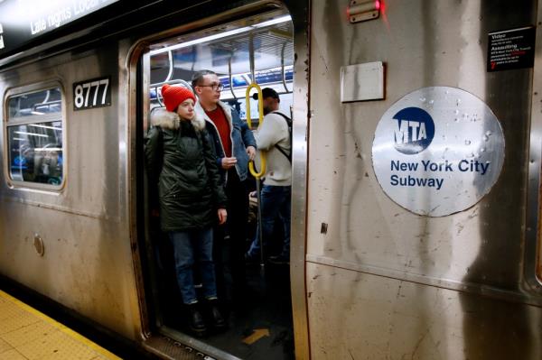 subway riders in a packed train car earlier this month