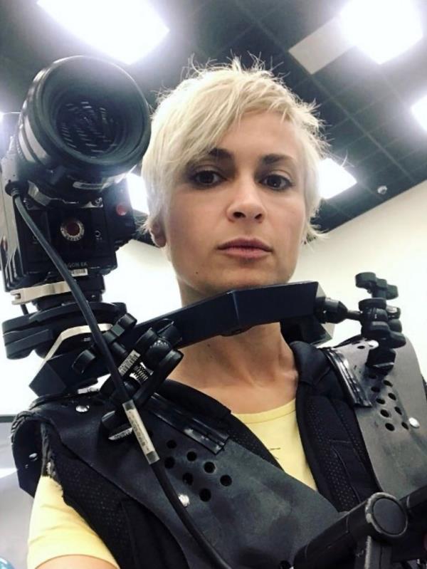 Halyna Hutchins holding a movie camera.