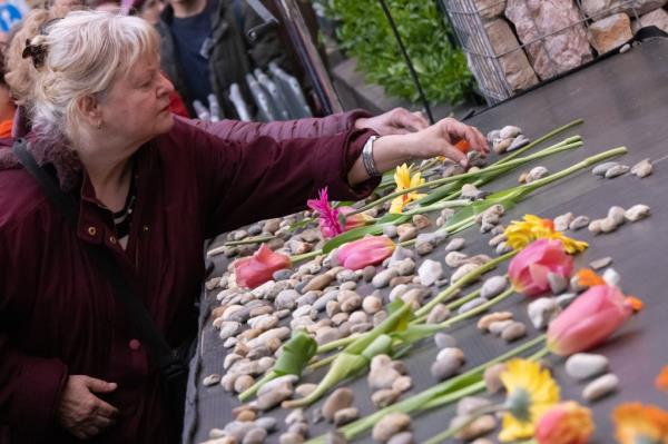 A woman laying a stone at a Holocaust memorial in Budapest on April 16, 2023.