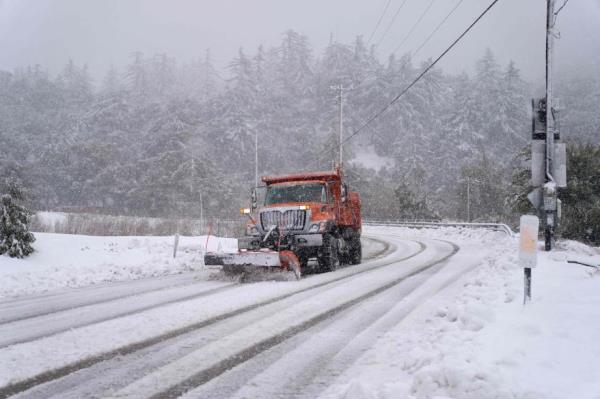 A plow clears snow on Mount Baldy Road in the town of Mount Baldy, California, on February 24, 2023.