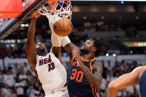 Heat center Bam Adebayo dunks over Knicks forward Julius Randle.