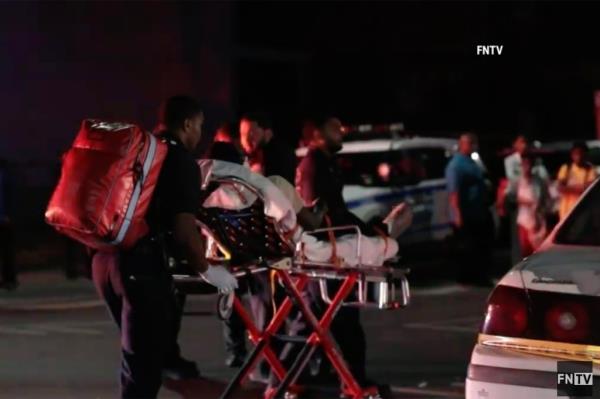 A victim involved in the crash is seen being taken away from the scene by EMS.