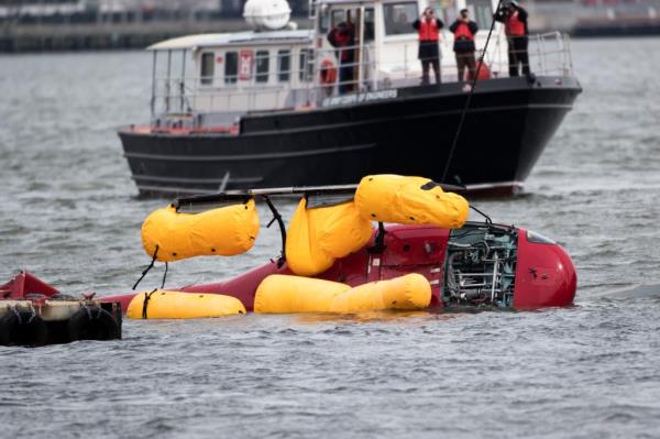 Salvage teams work to recover the FlyNYON flight tail after the deadly crash.