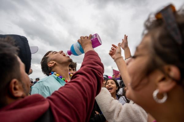 Despite gray skies and blustery conditions, hundreds of Gen Z party animals stripped down and drank up during a daylight rave on Clayton's Beach. 