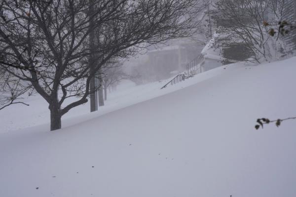 Snow drifts over the sidewalk on West Delavan Avenue in Buffalo, N.Y. on Saturday, Dec. 24, 2022. 