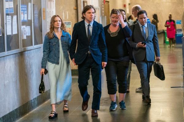 Matthew Shultz, second from the left, is pictured walking in the courthouse.